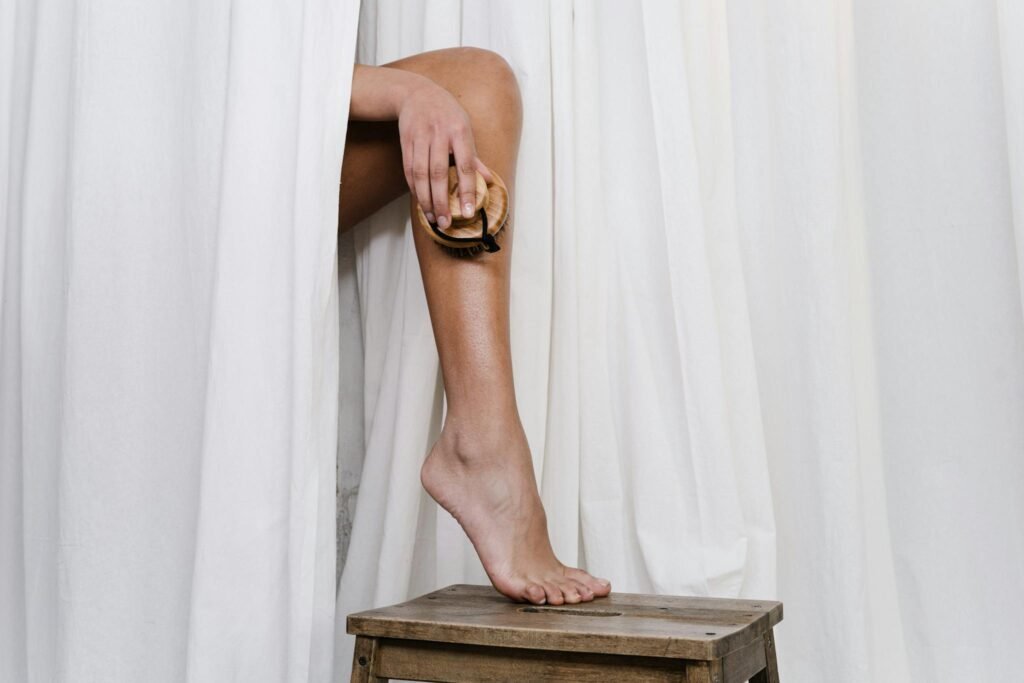 A close-up of a person using a dry brush for eco-friendly skincare.